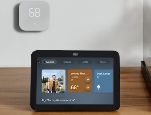 Amazon Echo Show 8 on desk under smart thermostat