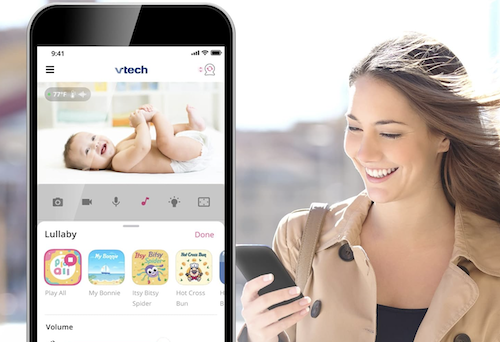 Woman on smartphone looking at VTech baby monitor smartphone app