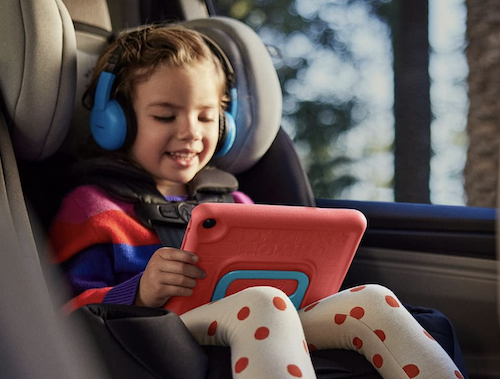 girl in carseat on an Amazon Fire 7 Kids tablet