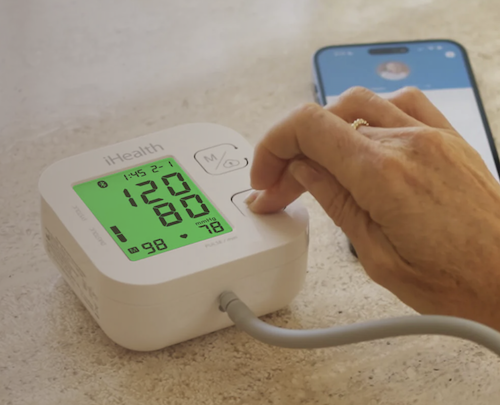 woman using smart blood pressure monitor